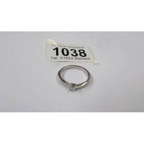 1038 - A platinum diamond solitaire ring, size O half, 2.6 grams.