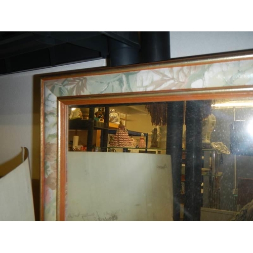 721 - A long rectangular mirror in fancy coloured frame. COLLECT ONLY.