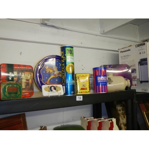 738 - A shelf of collector's tins.