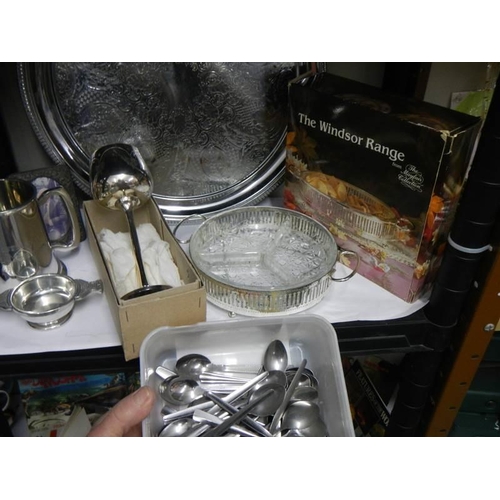 764 - A mixed lot of metal ware including tray, cutlery etc.,