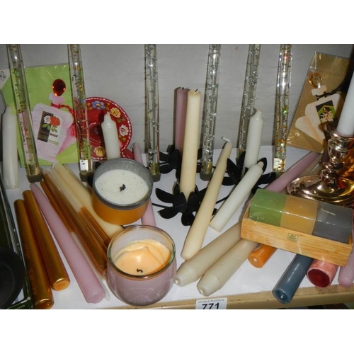 771 - A mixed lot of candlesticks and candles.