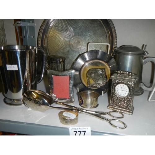 777 - A mixed lot of plated items including tray, tongs, clock etc.,