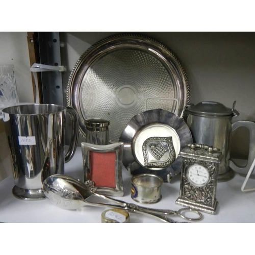 777 - A mixed lot of plated items including tray, tongs, clock etc.,