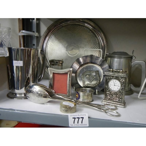 777 - A mixed lot of plated items including tray, tongs, clock etc.,