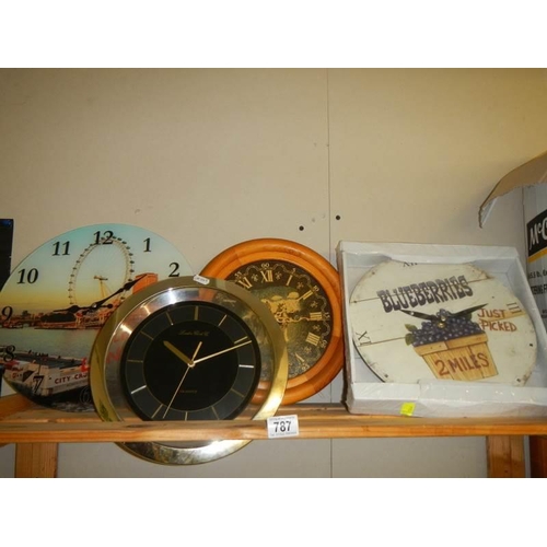 787 - A shelf of assorted wall clocks.