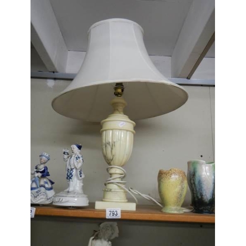 793 - A heavy table lamp with shade.