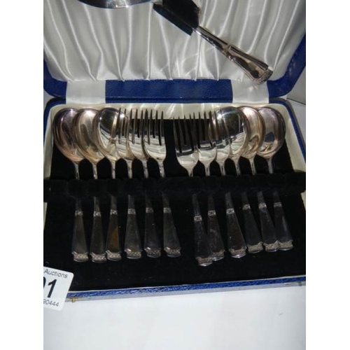 801 - A cased set of dessert spoons and forks with serving spoon.