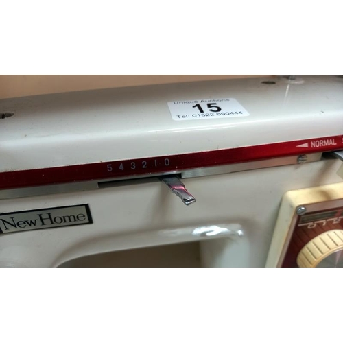 15 - A cased New Home sewing machine. COLLECT ONLY