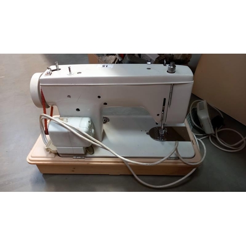 15 - A cased New Home sewing machine. COLLECT ONLY