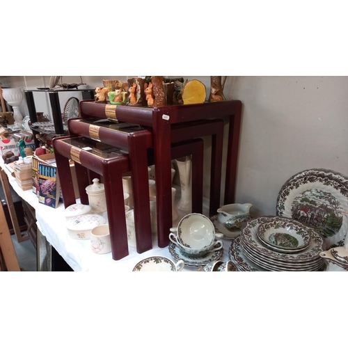 117 - A mahogany nest of tables with glass tops. COLLECT ONLY