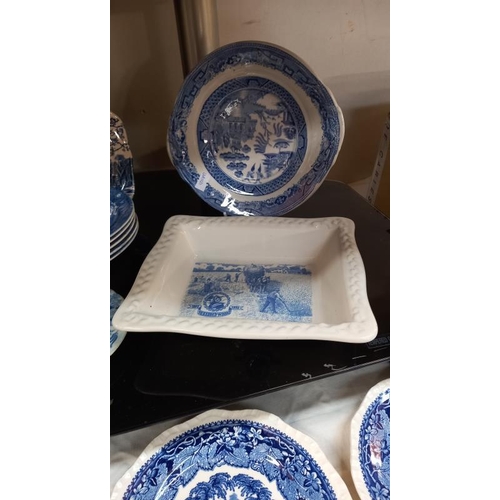 129 - A quantity of blue & white dishes/plates including 2 Shredded Wheat dishes