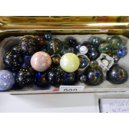 999 - A tin box full of large & small glass marbles