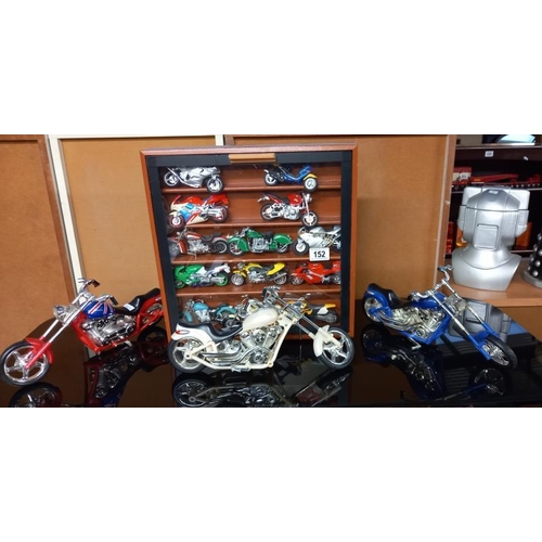 152 - A collection of plastic motorbike models including a display case