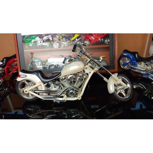 152 - A collection of plastic motorbike models including a display case