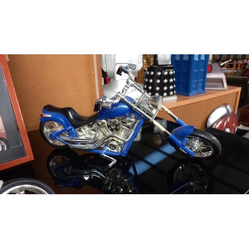 152 - A collection of plastic motorbike models including a display case