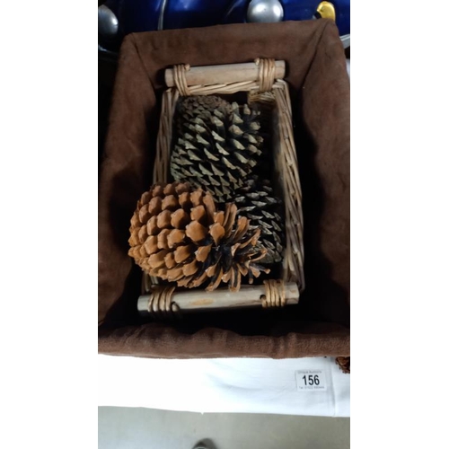 156 - A quantity of large pine cones and 3 wicker baskets