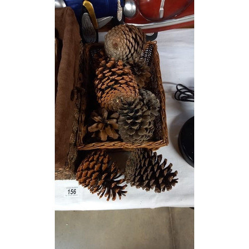 156 - A quantity of large pine cones and 3 wicker baskets