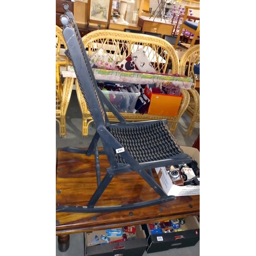 217 - A vintage folding campaign rocking chair painted and re-covered