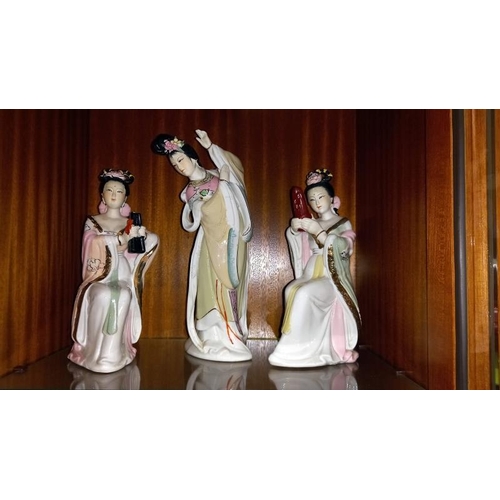 352 - An 8 piece band of Chinese pottery Geisha musician figurines and 2 others