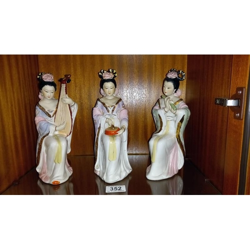 352 - An 8 piece band of Chinese pottery Geisha musician figurines and 2 others