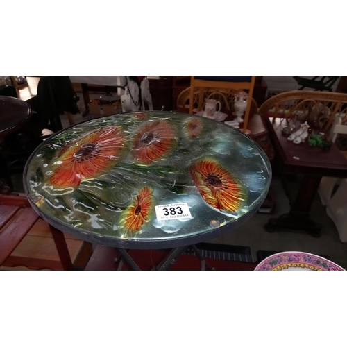 383 - A wrought iron folding garden table with 3D coloured glass poppy top, Diameter 35.5cm x height 49.5c... 
