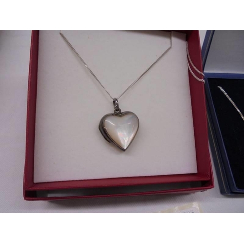 2001 - A silver and mother of pearl heart locket and an unmarked amber pendant.