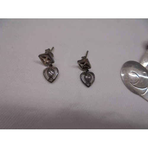 2003 - A pair of silver Macintosh earrings and a Mexican silver cat brooch.