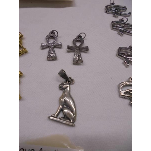 2011 - Two silver Egyptian 'Bastet' Goddess of Joy and Protector of Women brooches and other yellow and whi... 