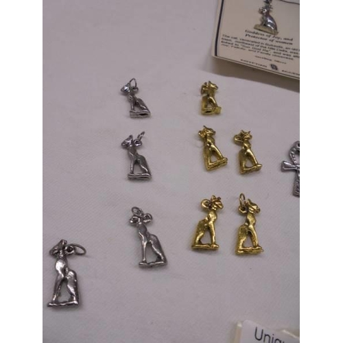 2011 - Two silver Egyptian 'Bastet' Goddess of Joy and Protector of Women brooches and other yellow and whi... 