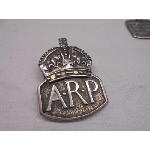 2012 - A silver ARP badge two silver pendants and a silver thimble.