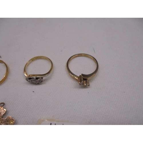 2013 - Four 9ct gold rings and a 9ct gold cross, 7.3 grams.