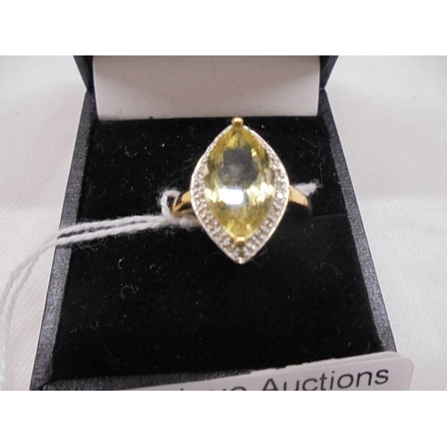 2019 - A marquis shaped citrine and diamond yellow gold ring, size T, 3 grams.