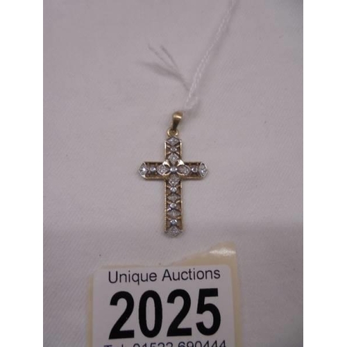 2025 - A 9ct yellow gold and diamond cross, 2 grams.