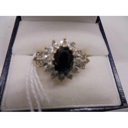 2027 - A large raised sapphire and diamond yellow gold ring, size K, 3.1 grams.