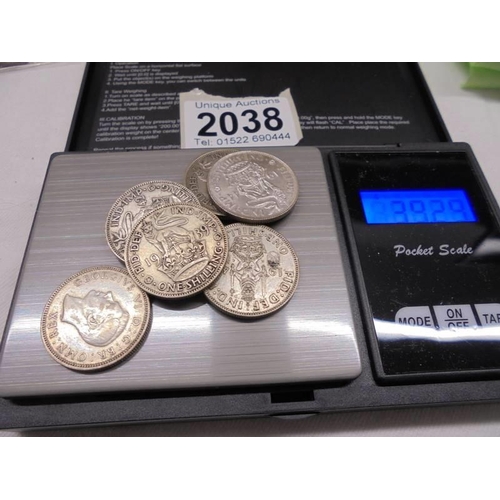 2038 - Seven George V silver shillings, approximately 39 grams.