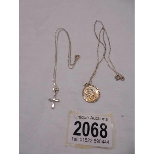 2068 - A silver St. Christopher on chain and a silver cross on chain, 6.2 grams.