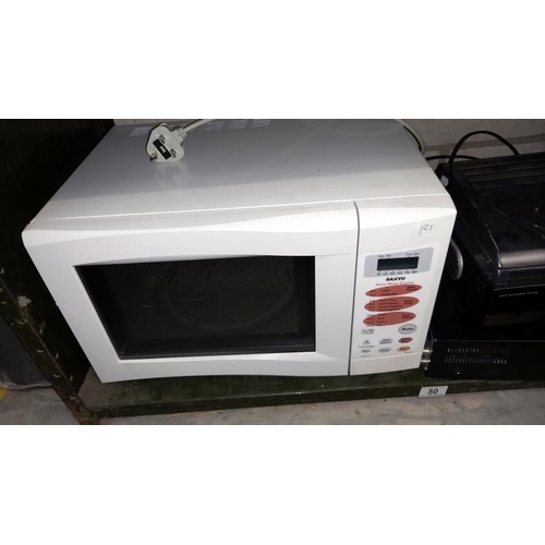 50 - A Panasonic DMR-EZ49V VHS DVD Player and a Steepletone Record Player and a Sanyo Microwave.