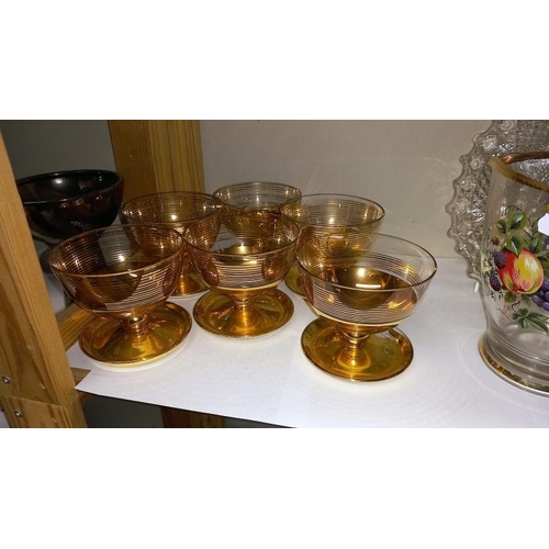 8 - A Set of Six Gilded Glass Fruit Bowls, a fruit decorated water jug and a glass plate.