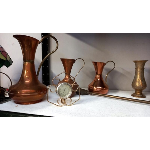 100 - A selection of copper and brass including jugs, letter rack, hunting horn etc.,