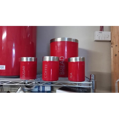 131 - A Red kitchen waste bin storage container, kettle and storage canisters.