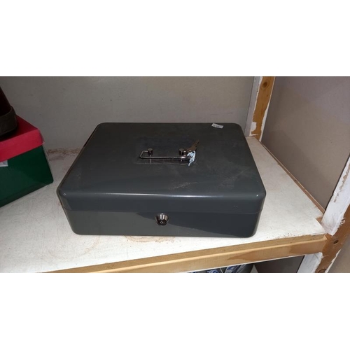 223 - A cash box with keys, drill bits, accessories, new window kit, work boots size 10 etc (2 shelves)