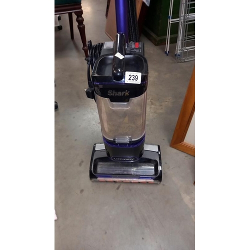 239 - A Shark corded upright vacuum and accessories