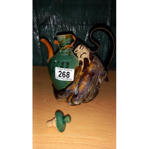 268 - A Chinese figural pottery teapot & a figure