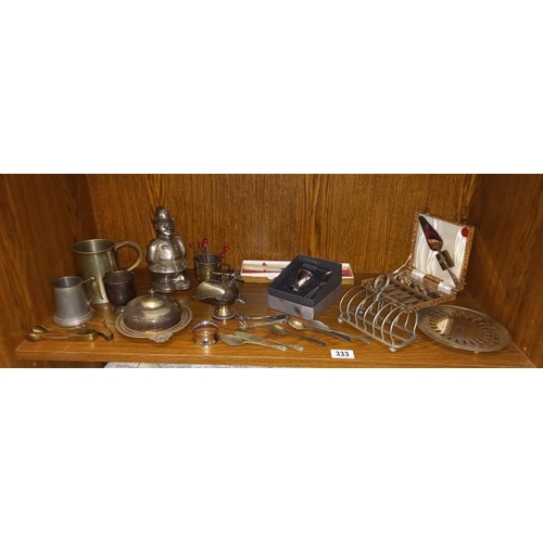 333 - A quantity of silver plated items including toast racks, butter dish and policeman money box etc.