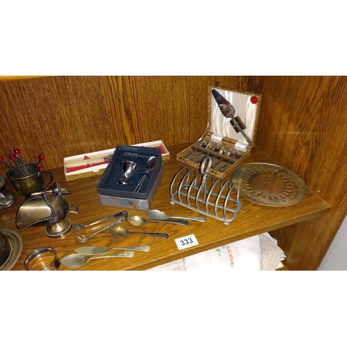 333 - A quantity of silver plated items including toast racks, butter dish and policeman money box etc.