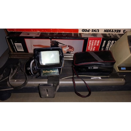 359 - A shelf of photographic aids / accessories, Slide viewer, Light meter camera stand (monopod)