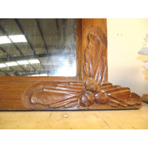 1056 - An oak over mantle mirror with acorn and leaf carvings in 3 places 76cm x 76cm, total width 92cm COL... 