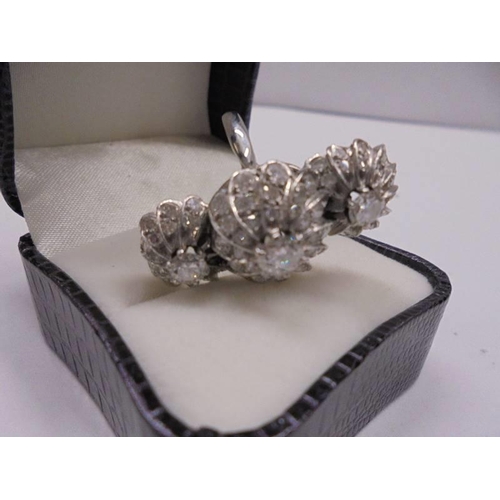 2030A - An 18ct white gold triple cluster diamond ring, size N, total weight 8 grams.