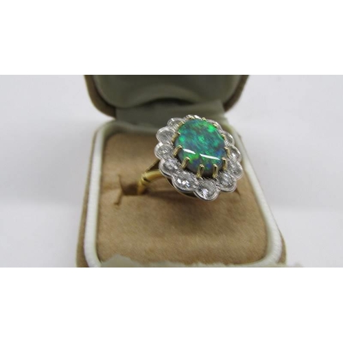 2030E - An 18ct gold opal and diamond ring, size M, total weight 6.8 grams.