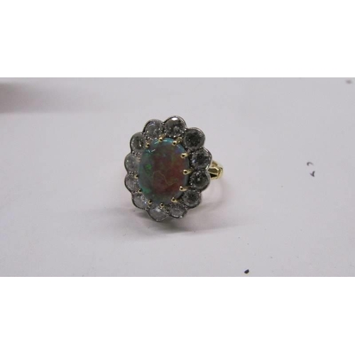 2030E - An 18ct gold opal and diamond ring, size M, total weight 6.8 grams.